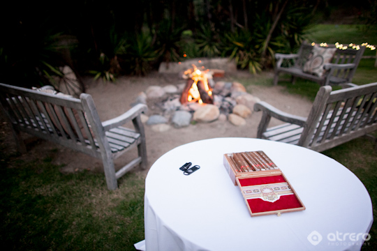 Cozy outdoor scene with fire pit and cigars for a relaxing evening