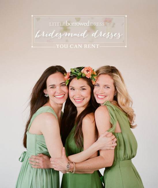 Three bridesmaids in green dresses embrace each other