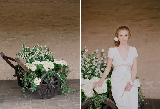 Woman in white dress beside flower cart