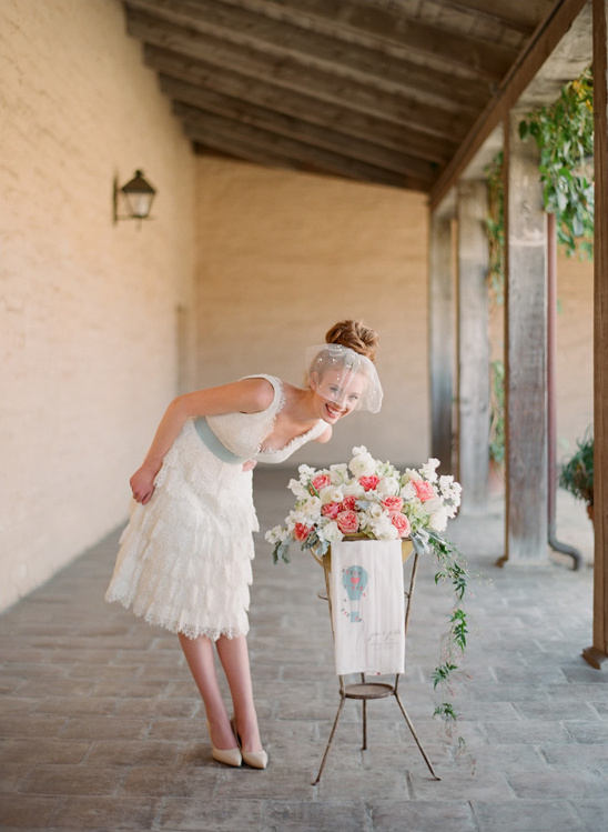 Bride in lace dress, floral display