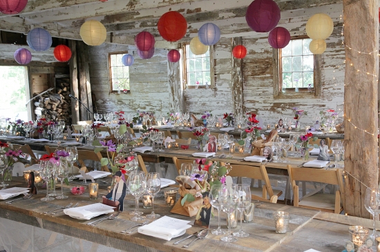 Rustic barn wedding reception with colorful lanterns