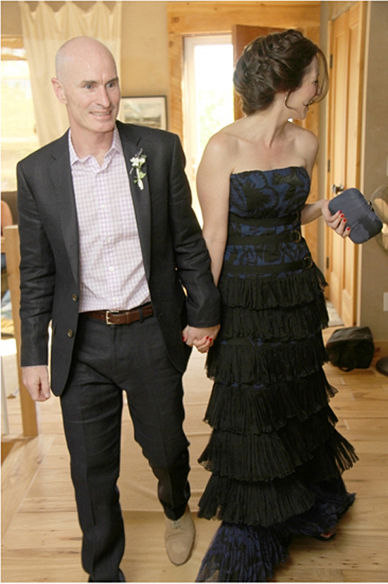 Newlyweds holding hands and smiling at their wedding