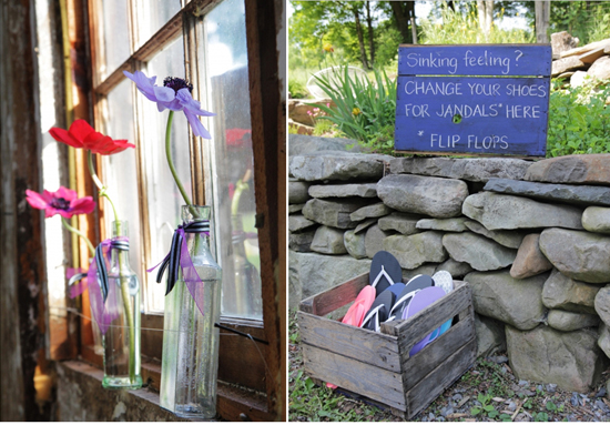 Colorful flowers in vases and a flip-flop sign near a stone wall