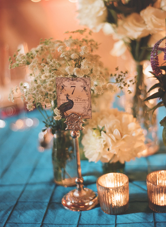 Wedding table setting with flowers and vintage table number