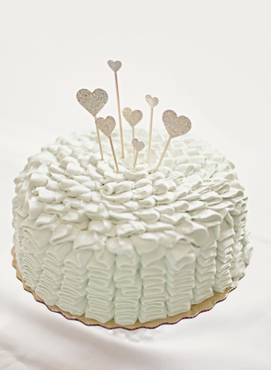 Elegant light mint cake with heart toppers