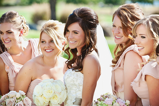 Bride and bridesmaids smiling on a beautiful wedding day celebration