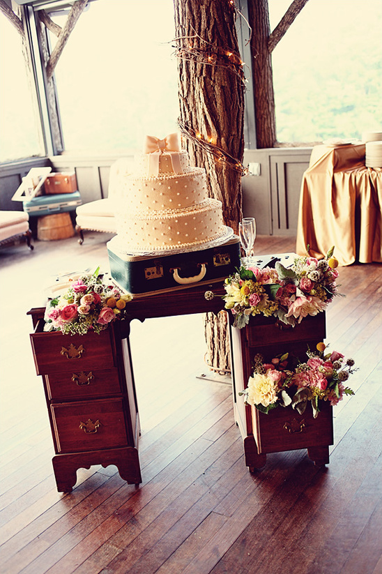 Rustic wedding cake on vintage suitcase stand