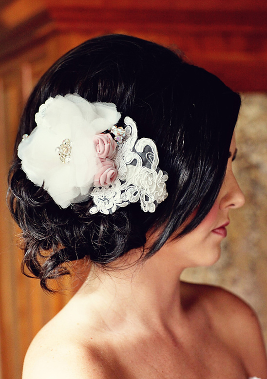 Bride with elegant lace and flower hair accessory