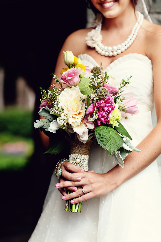 Bride holding beautiful pastel wedding bouquet