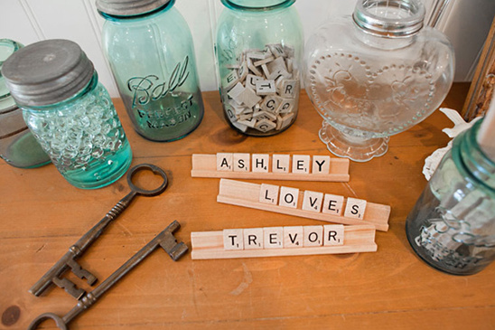 Names written on wooden tiles with glass jars