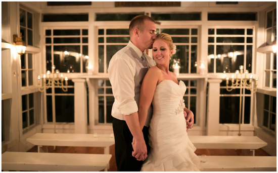 Romantic wedding couple embracing in a lovely, candlelit room