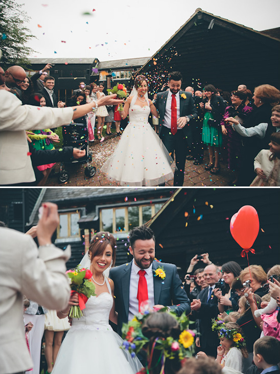 Joyful newly wedded couple showered with confetti on their wedding day