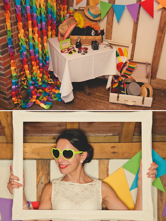 Wedding guest posing with heart sunglasses in photo booth