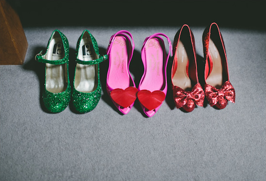 Three pairs of colorful women's shoes on a soft grey surface