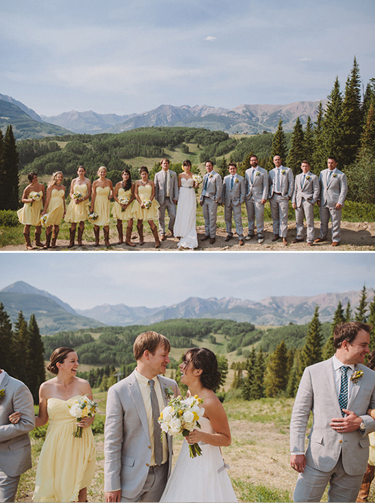 Wedding party posing for a photo with mountain scenery in the background