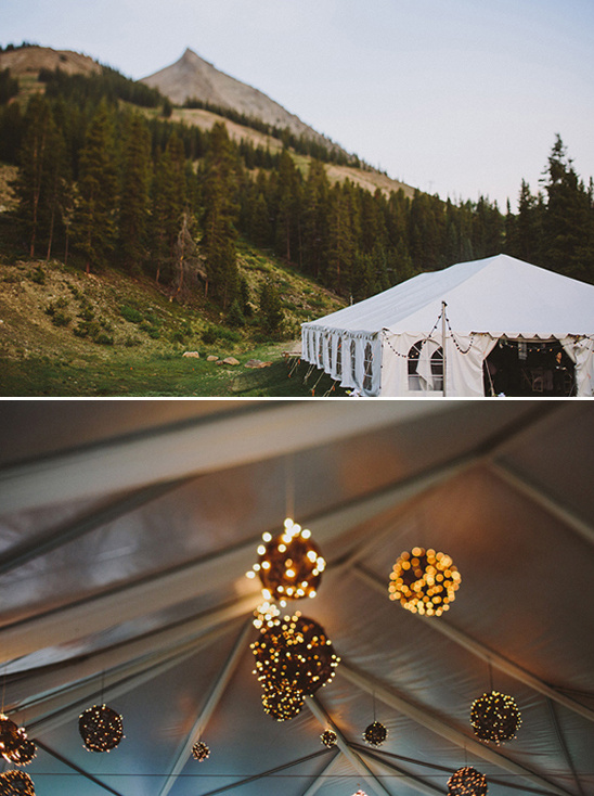 Wedding tent in mountains with string lights and decorations