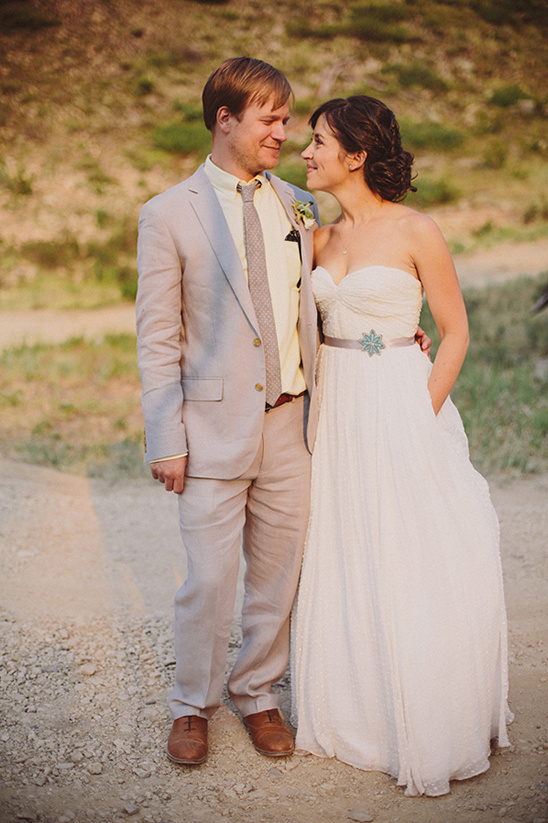 Happy couple on their wedding day looking at each other fondly