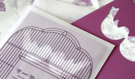 Elegant wedding invitations with bird cutouts and floral details
