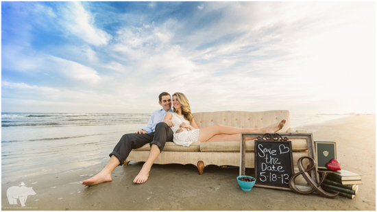 Romantic couple on a beach with a Save the Date sign