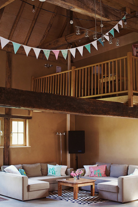 Cozy interior with comfortable sofas, pennant flags, and wooden beams