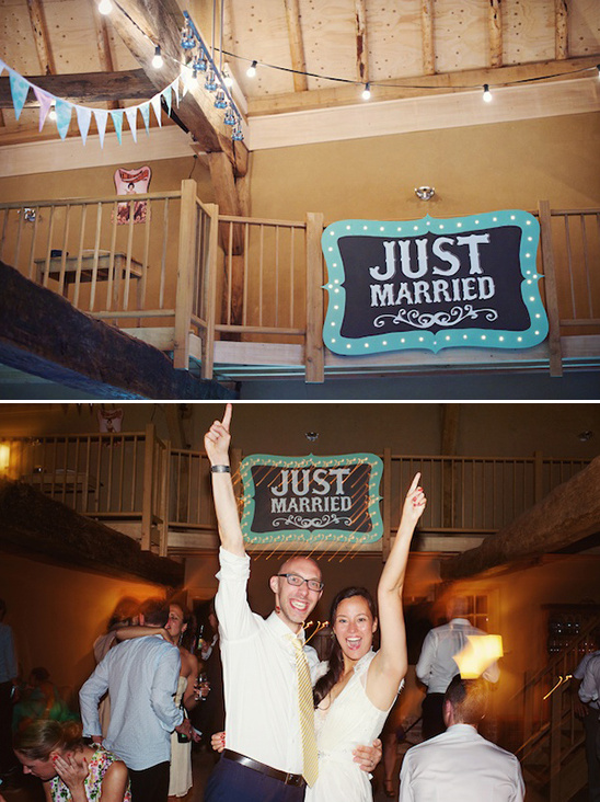 Wedding reception with Just Married sign and happy couple celebrating