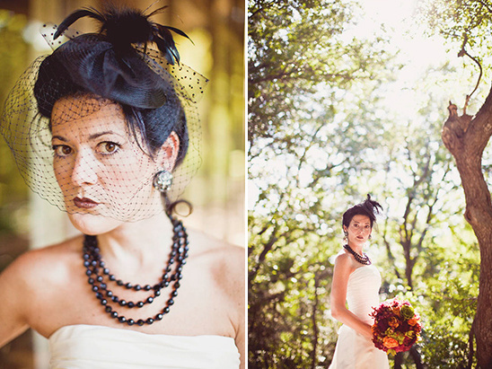 Bride in a black headpiece and veil, holding bouquet in a forest