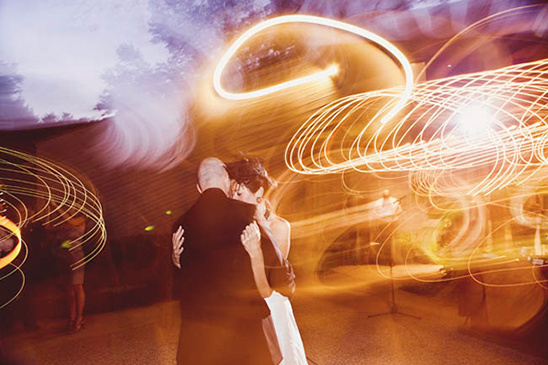 Wedding couple dancing under beautiful light trails