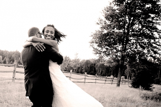 Happy bride embracing her groom on their wedding day outdoors