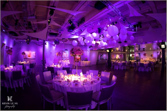 Elegant wedding reception venue with purple lighting and decor