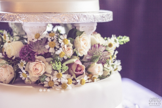 Elegant wedding cake with fresh flower decorations close-up