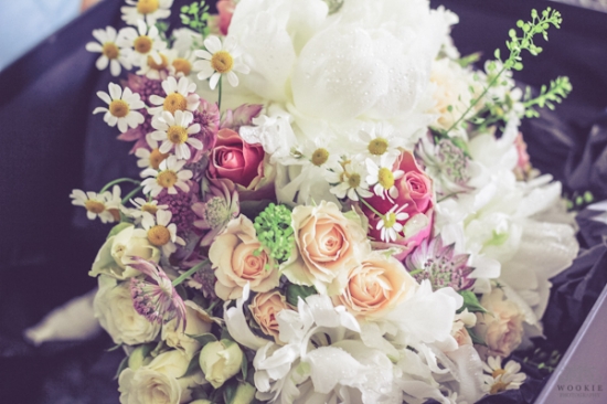 Beautiful wedding bouquet featuring roses and daisies in bloom