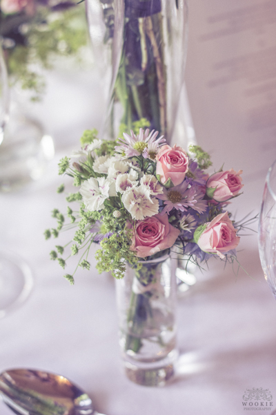 Elegant floral centerpiece with pink roses in a clear glass vase