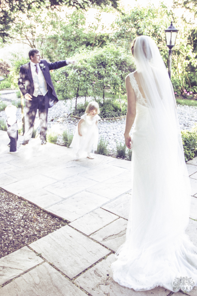 Bride and father with a flower girl at a wedding outdoors