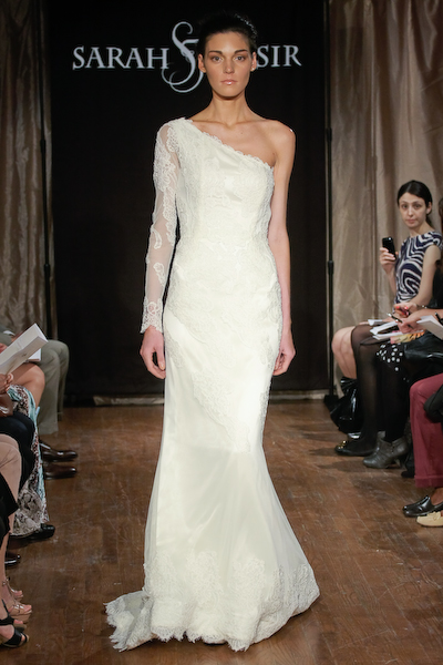 Elegant one-shoulder lace wedding dress on a fashion runway