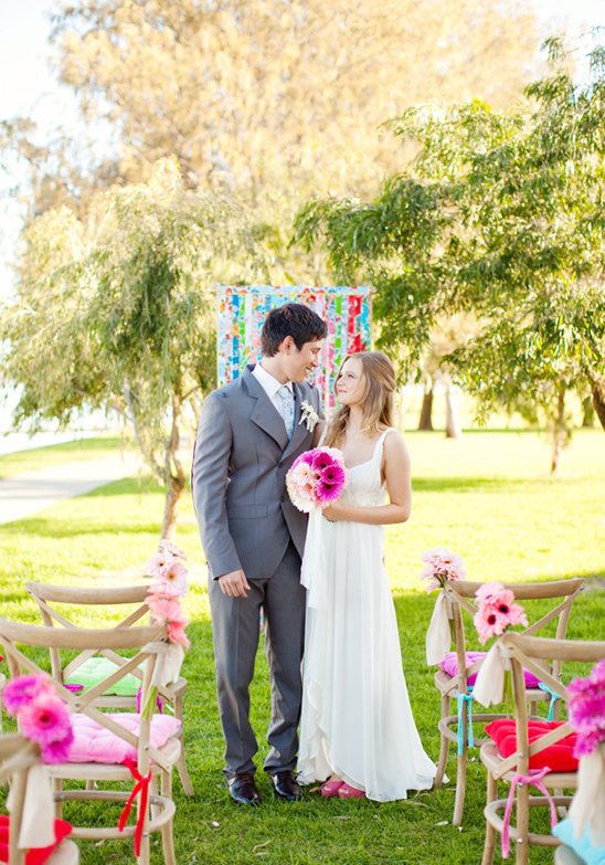 Happy couple at outdoor wedding ceremony with floral decor
