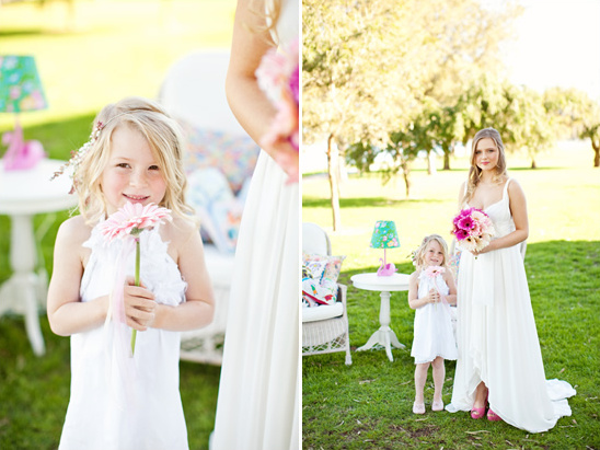 Smiling flower girl with a daisy at an outdoor wedding