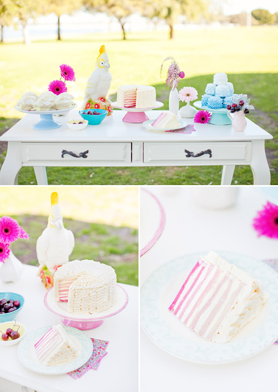 Beautiful outdoor dessert table with cake and vibrant decorations