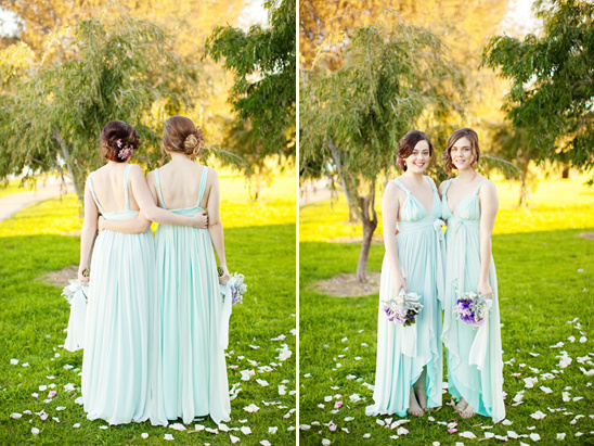 Bridesmaids wearing long light blue dresses in a garden