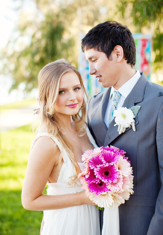 Happy bride and groom smile on their wedding day with flowers