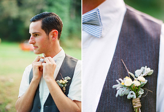Groom adjusting bowtie, wearing vest with floral boutonniere, at wedding