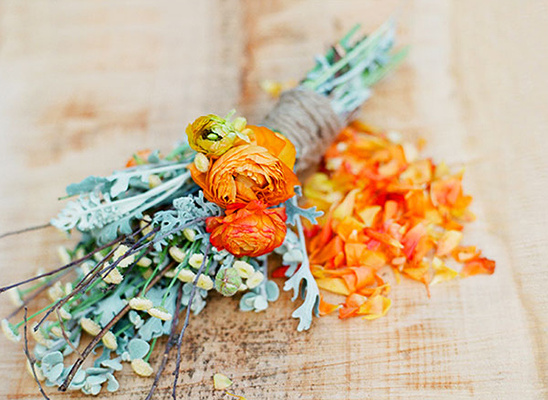 Rustic floral arrangement with orange blooms and grey leaves