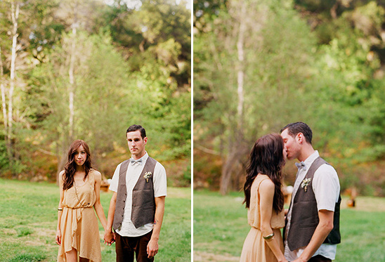 Romantic couple holds hands, then shares a kiss in a park setting