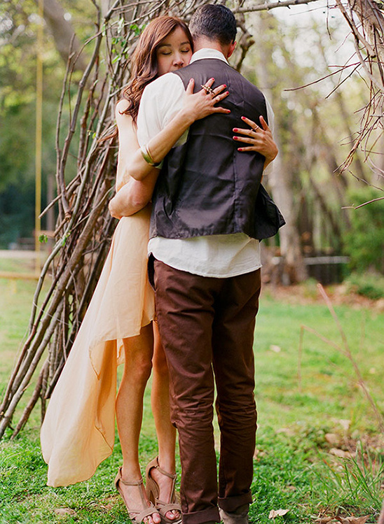 Couple embracing lovingly outdoors in a peaceful garden setting