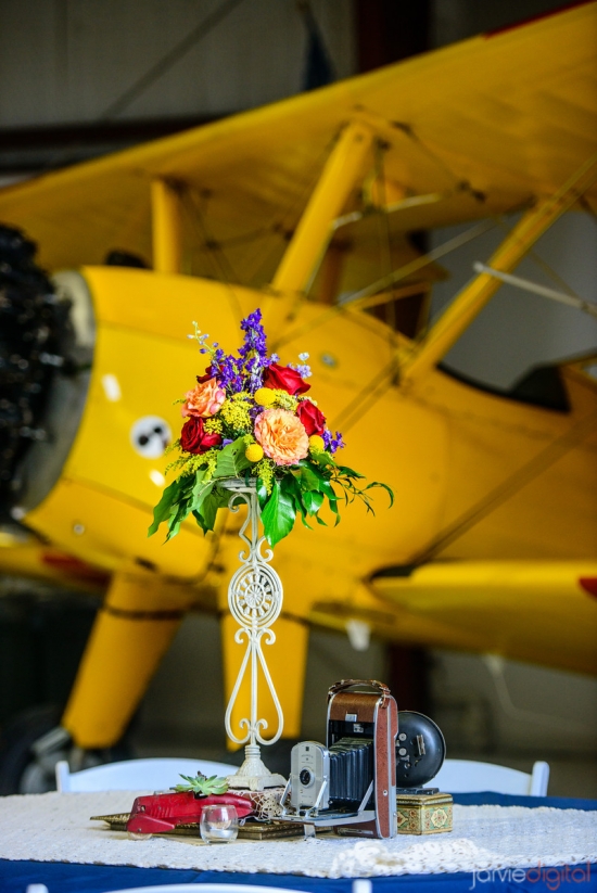 Vintage airplane themed table setting with flowers and decor
