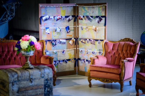 Vintage seating decorates room with photos displayed on maps