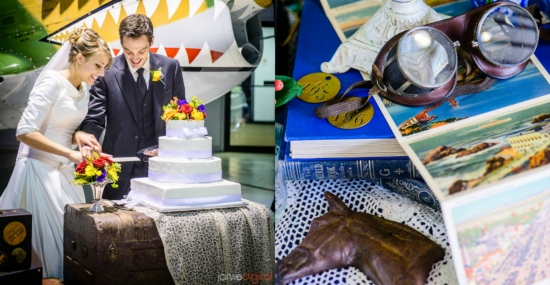 Bride and groom cut the cake next to vintage items and postcards