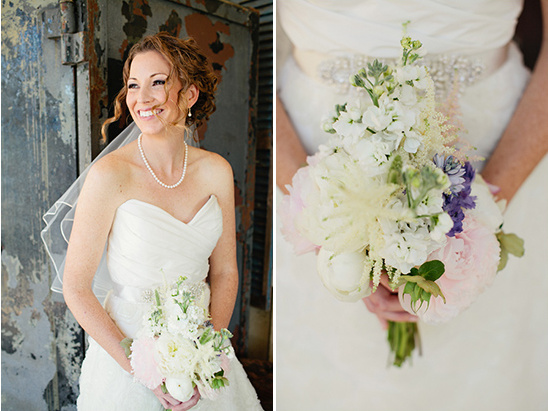 Smiling bride in white dress holding bouquet of flowers