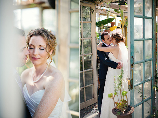 Bride and groom kissing at their greenhouse wedding