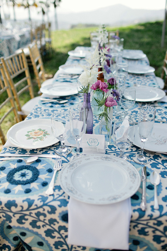 Outdoor wedding table setting with blue patterned linens