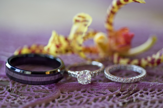 Elegant wedding rings displayed with a vibrant orchid